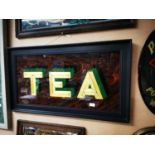 Tea on glass framed advertising sign.