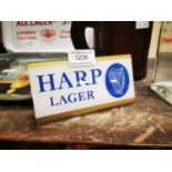 Harp Lager counter advertising sign.