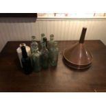 Collection of antique bottles & a copper funnel
