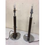 A pair of timber and chrome lamps