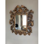 Regency style profusely carved and gilded centre mirror