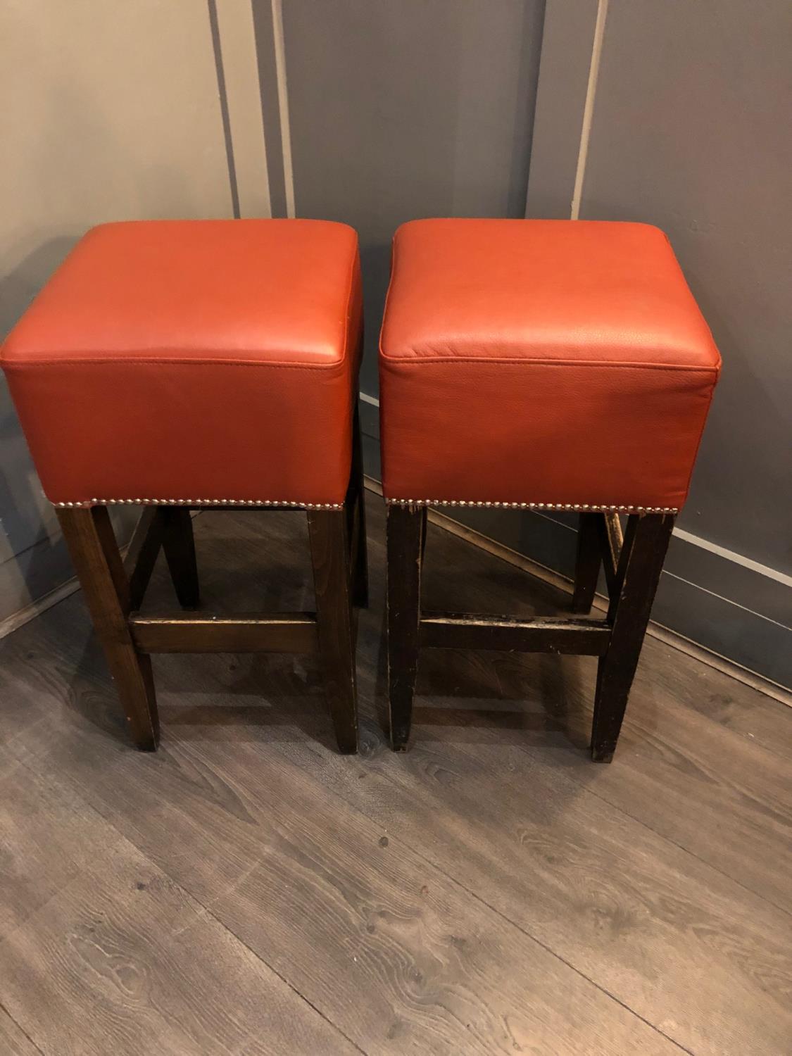 Pair of tall bar stools with red leather upholstery W 36cm H 74cm