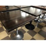 2 rectangular topped bar tables one with chrome and the other with wrought iron base