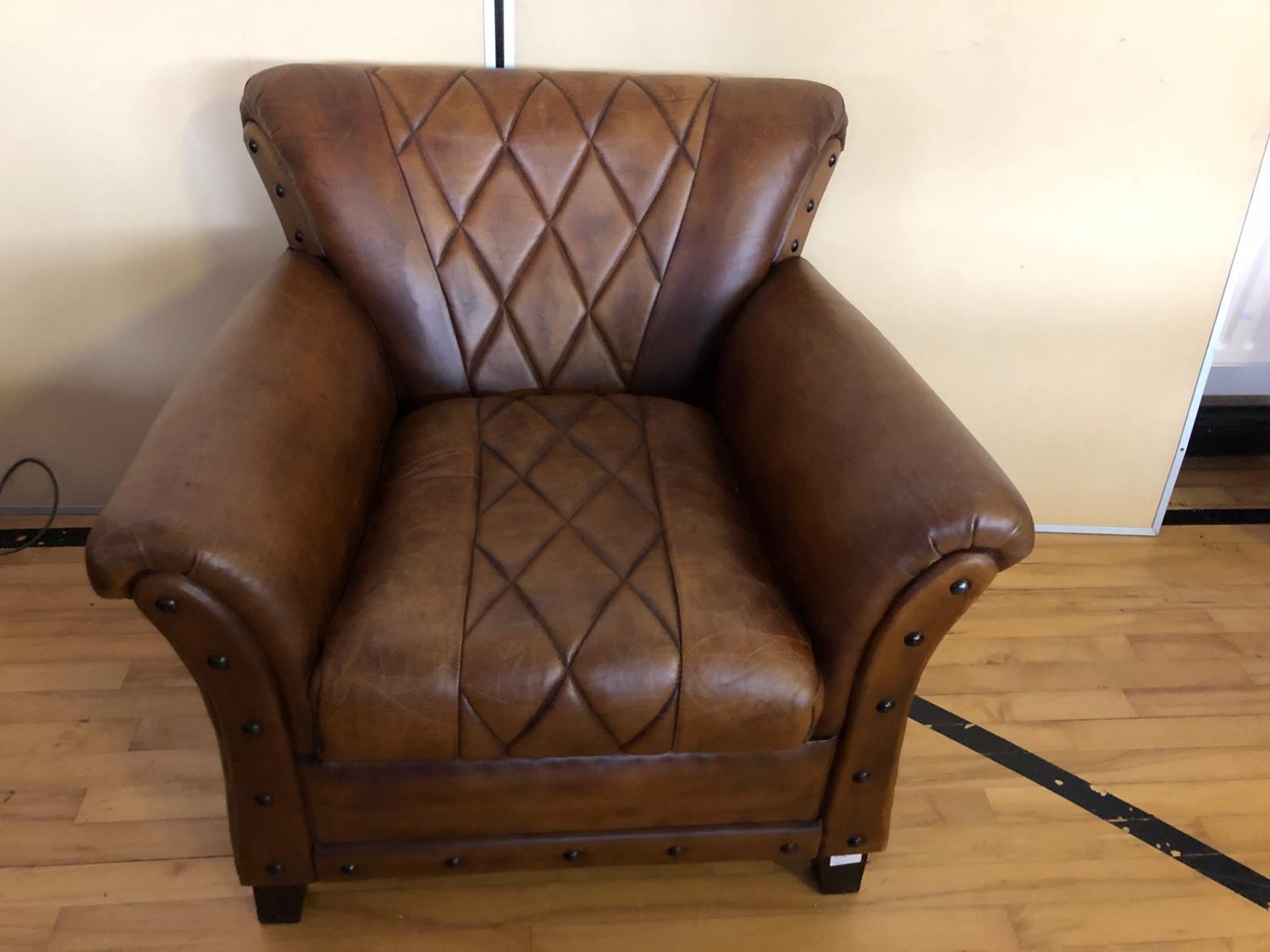 Fine leather armchair with geometric pattern and deep buttoned embellishment W 90cm H 80cm D 80cm