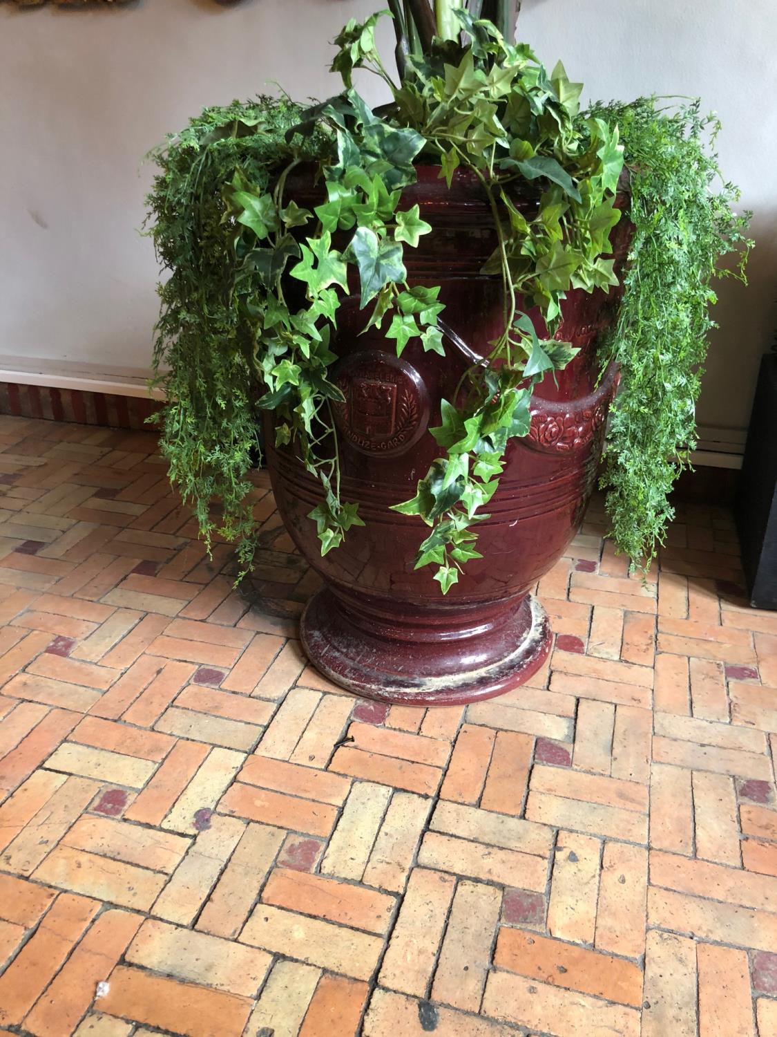 French glazed pot burgundy colour complete with foliage W 55cm H 70cm