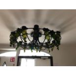 Very decorative wrought iron centre light embellished with wine bottles W 120cms H 40cms