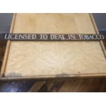 Bronze signed "LICENSED TO DEAL IN TOBACCO" W 50cm H 4cm