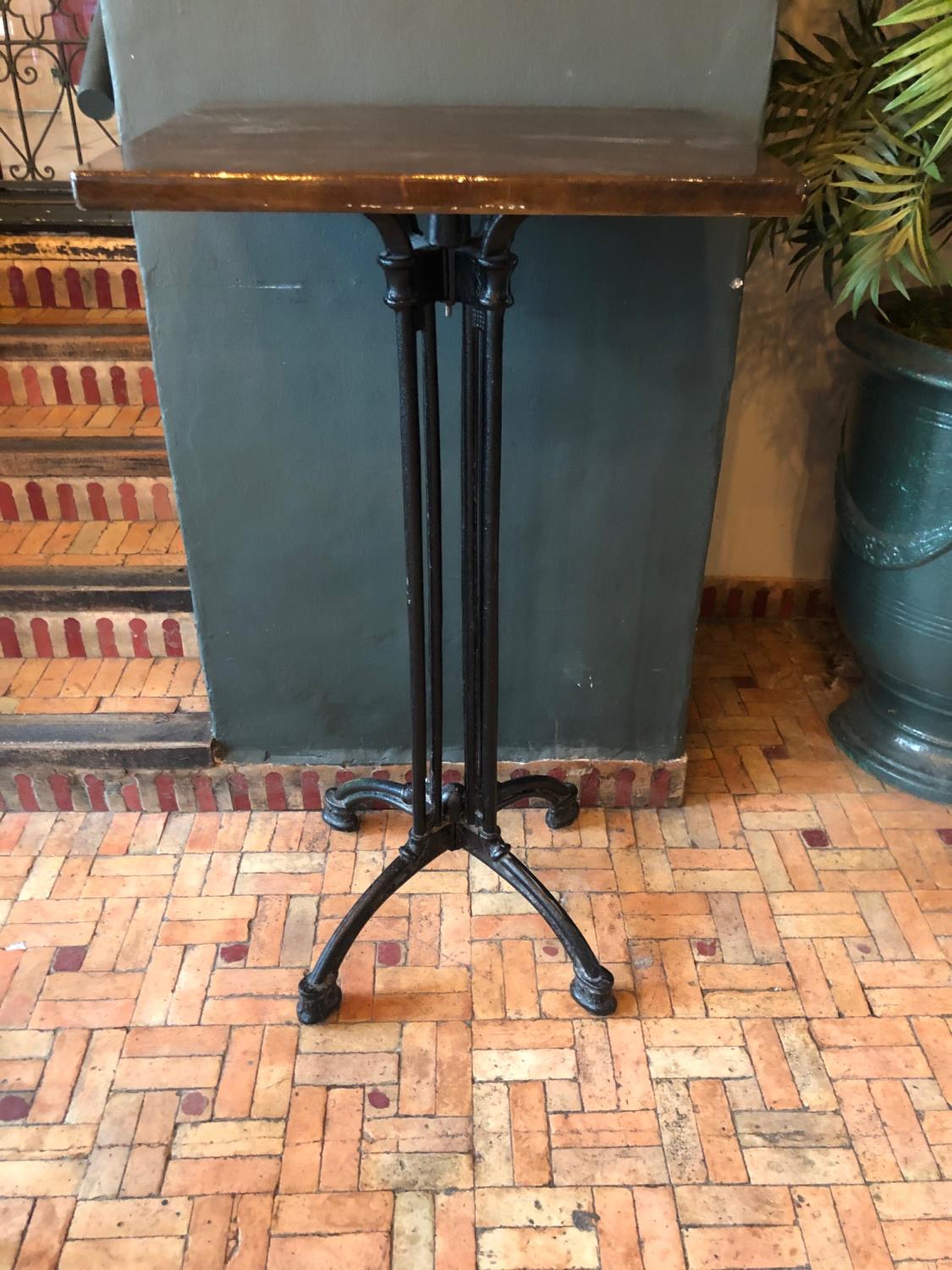 Pair of tall restaurant tables with cast iron bases W 60cm H 110cm D 50cm