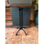 Pair of tall restaurant tables with cast iron bases W 60cm H 110cm D 50cm
