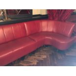 Fixed seating in red leather standing on turned feet W 530cm H 90cm D 125cm