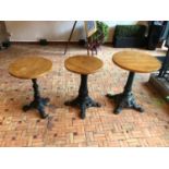 Three Graduated restaurant tables with decorative cast iron bases Largest W 60cm H 75cm