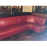 Fixed seating in red leather standing on turned feet W 530cm H 90cm D 125cm