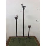 Three graduated candle stands, tallest 115cm H