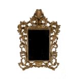 Gilded and carved wooden mirror. Early 20th c.