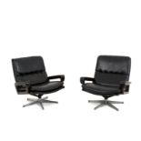 Italian pair of swivel armchairs in black sky