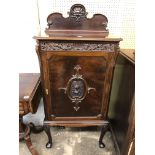 EDWARDIAN MAHOGANY MUSIC CABINET WITH SHELL CARVED LEDGE AND FRIEZE THE DOOR OPENING TO REVEAL PULL