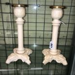 PAIR OF 19TH CENTURY IVORY CANDLESTICKS WITH CARVED RAMSHEAD AND WOLF BASES-18CT GOLD NOZZLES 22.
