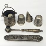 A SILVER EMBOSSED THIMBLE HOLDER IN FORM OF A PAIL, STERLING SILVER THIMBLE AND SILVER BODKIN CASE.