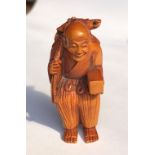 JAPANESE CARVED WOOD NETSUKE OF AN ELDERLY MAN CARRYING A TURTLE ON HIS BACK