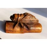 JAPANESE WOOD NETSUKE OF A LOCUST ON A SECTION OF BAMBOO
