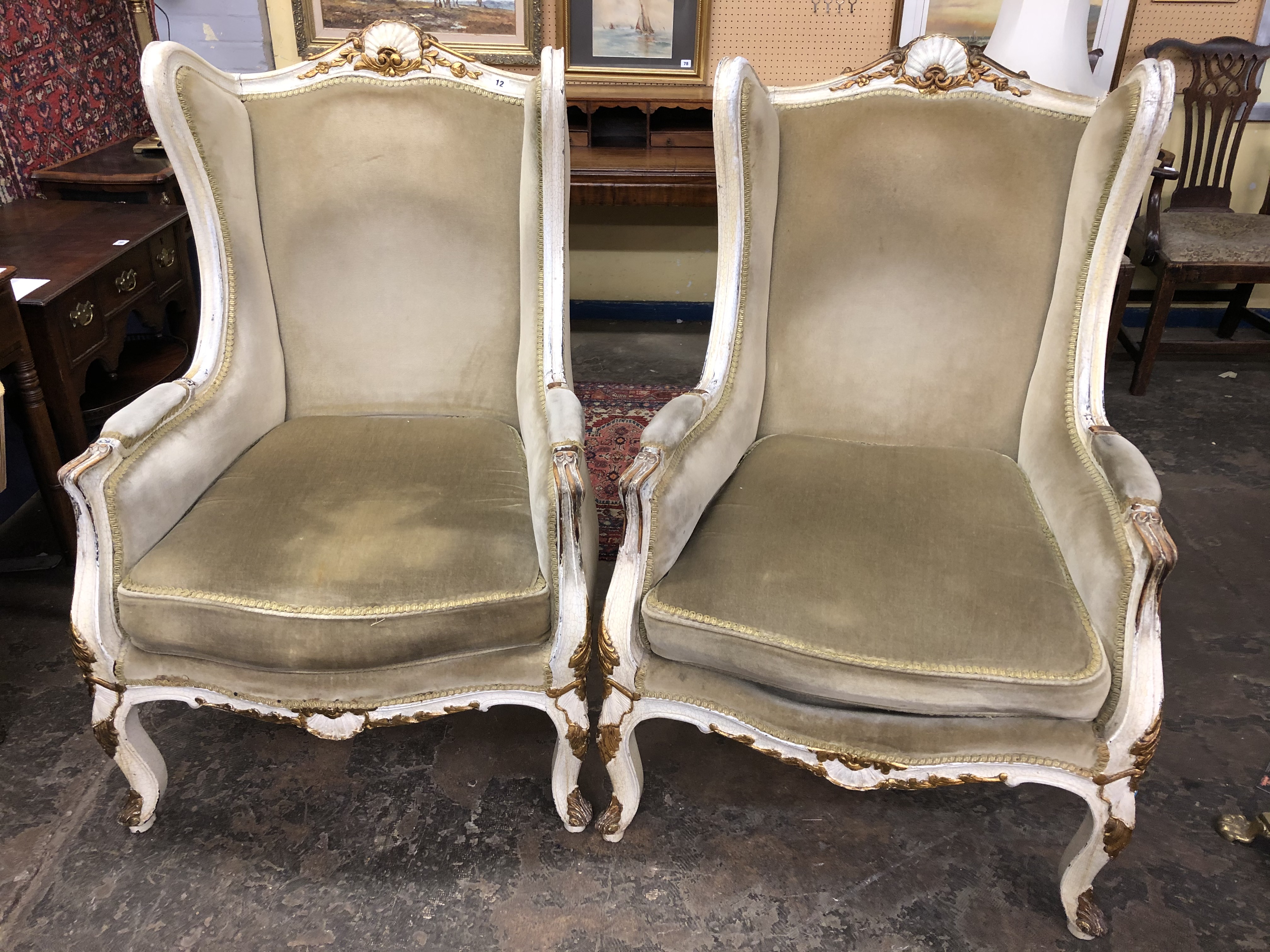 A PAIR OF EARLY 2OTHC FRENCH PAINTED AND UPHOLSTERD HIGH BACK ARMCHAIRS