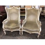 A PAIR OF EARLY 2OTHC FRENCH PAINTED AND UPHOLSTERD HIGH BACK ARMCHAIRS