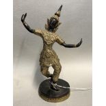 A BRONZE AND GILDED FIGURE OF A SIAM DANCER ON A CIRCULAR BASE