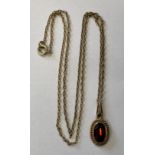 YELLOW METAL OVAL PENDANT 'RED STONE' ON TRACE CHAIN 46CM 3.