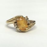9CT YELLOW GOLD TOPAZ AND DIAMOND CROSSOVER RING 3.
