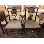 TWO MID 18TH CENTURY OAK PROVINCIAL ELBOW CHAIRS WITH PIERCED SPLATS AND DROP IN SEATS.