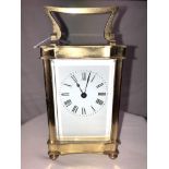 20TH CENTURY BRASS CARRIAGE CLOCK WITH ENAMEL DIAL AND SHAPED CARRYING HANDLE 15,