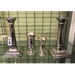 A PAIR OF SILVER TAPERED DWARF CANDLESTICKS ON STEPPED SQUARE BASES 1903(CREASES AND DENTS)10.