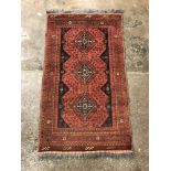 20TH CENTURY CARPET RUNNER WITH BLACK LOZENGE MOTIFS ON A RED BACKGROUND-FRINGED77CMX133CM