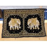 A SILK AND BLACK VELVET WALL HANGING WORKED IN GOLD THREAD EMBROIDERY DEPICTING TWO JEWELLED INDIAN