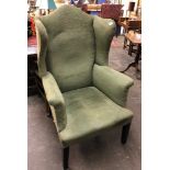 A GEORGIAN DESIGN HIGH WING BACK GENTLEMANS ARMCHAIR UPHOLSTERED IN GREEN FABRIC