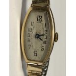 LADIES UNMARKED YELLOW METAL CASED TONNEAU WRIST WATCH ON EXPANDING STRAP 17.