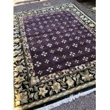 GOOD QUALITY CHINESE TYPE FLORAL CARPET WITH AN AUBERGINE CENTRAL GROUND WITHIN BLACK GROUND FLORAL