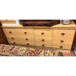 OAK EFFECT DOUBLE FRONTED CHEST OF DRAWERS AND A SIMILAR THREE DRAWER BEDSIDE CHEST