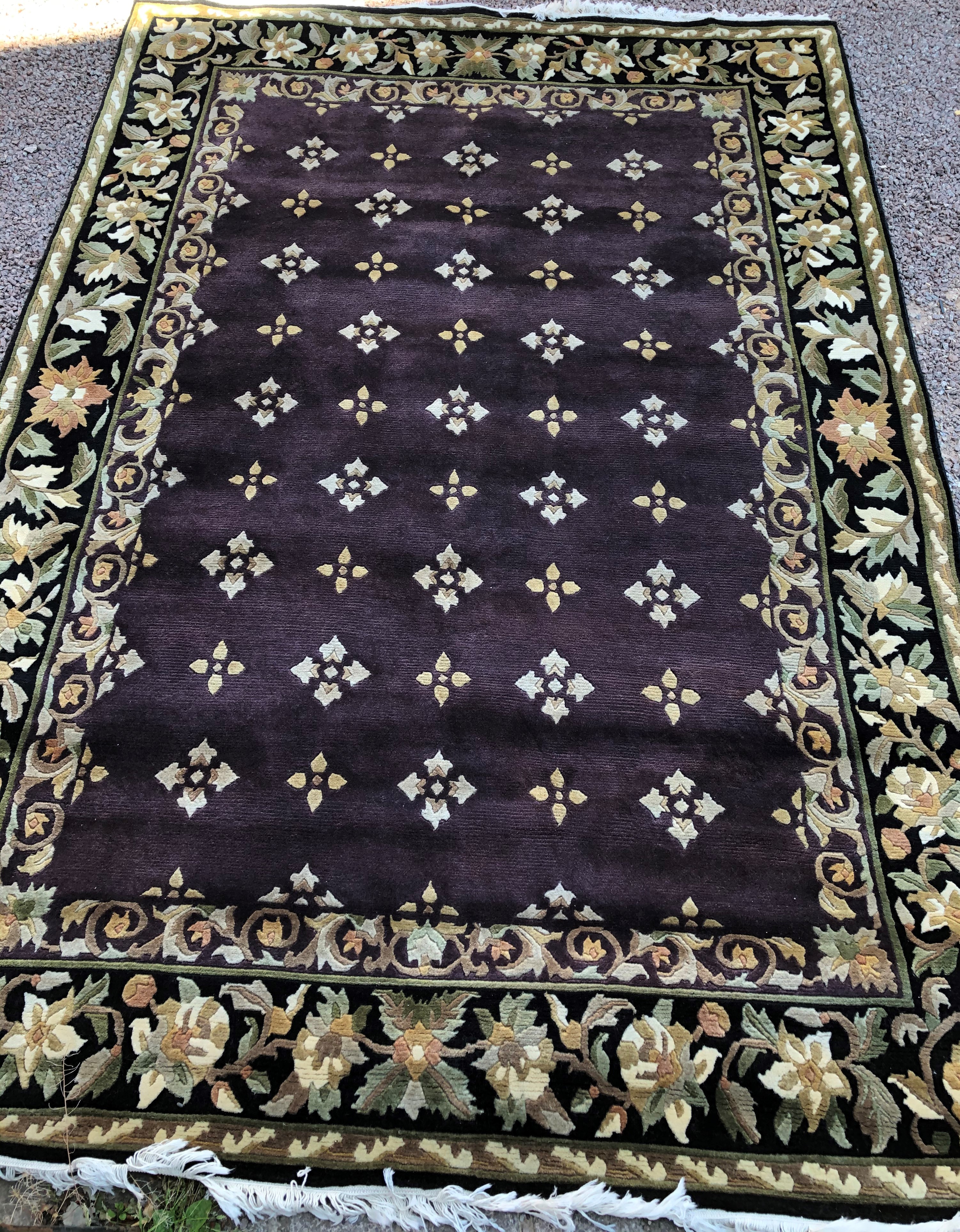 GOOD QUALITY CHINESE TYPE FLORAL CARPET WITH AN AUBERGINE CENTRAL GROUND WITHIN BLACK GROUND FLORAL