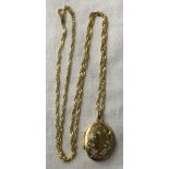 9CT GOLD OVAL LOCKET ON A 9CT GOLD TWIST LINK CHAIN 4.