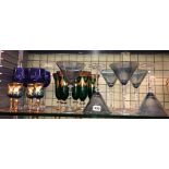 SHELF OF BLUE ETCHED AND GREEN GILDED GLASS GOBLETS