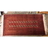 RED GROUND FRINGED CARPET RUNNER 197 X 102CM APPROX