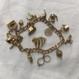 9CT GOLD FLAT LINK CURB BRACELET WITH 14 CHARMS, DOLPHIN'S TAIL A/F 29.