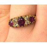 18CT GOLD THREE STONE RUBY AND DIAMOND RING SIZE N 4.