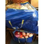 TWO HOLDALL BAGS OF CARPET THRUMS, KNITTING WOOLS,