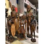 FIVE MASAI CARVED WOODEN MALE AND FEMALE FIGURES