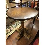 OLD MILL OAK CROSS BASED CIRCULAR OCCASIONAL TABLE AND A LEATHER TOPPED DEMI LUNE WALL TABLE