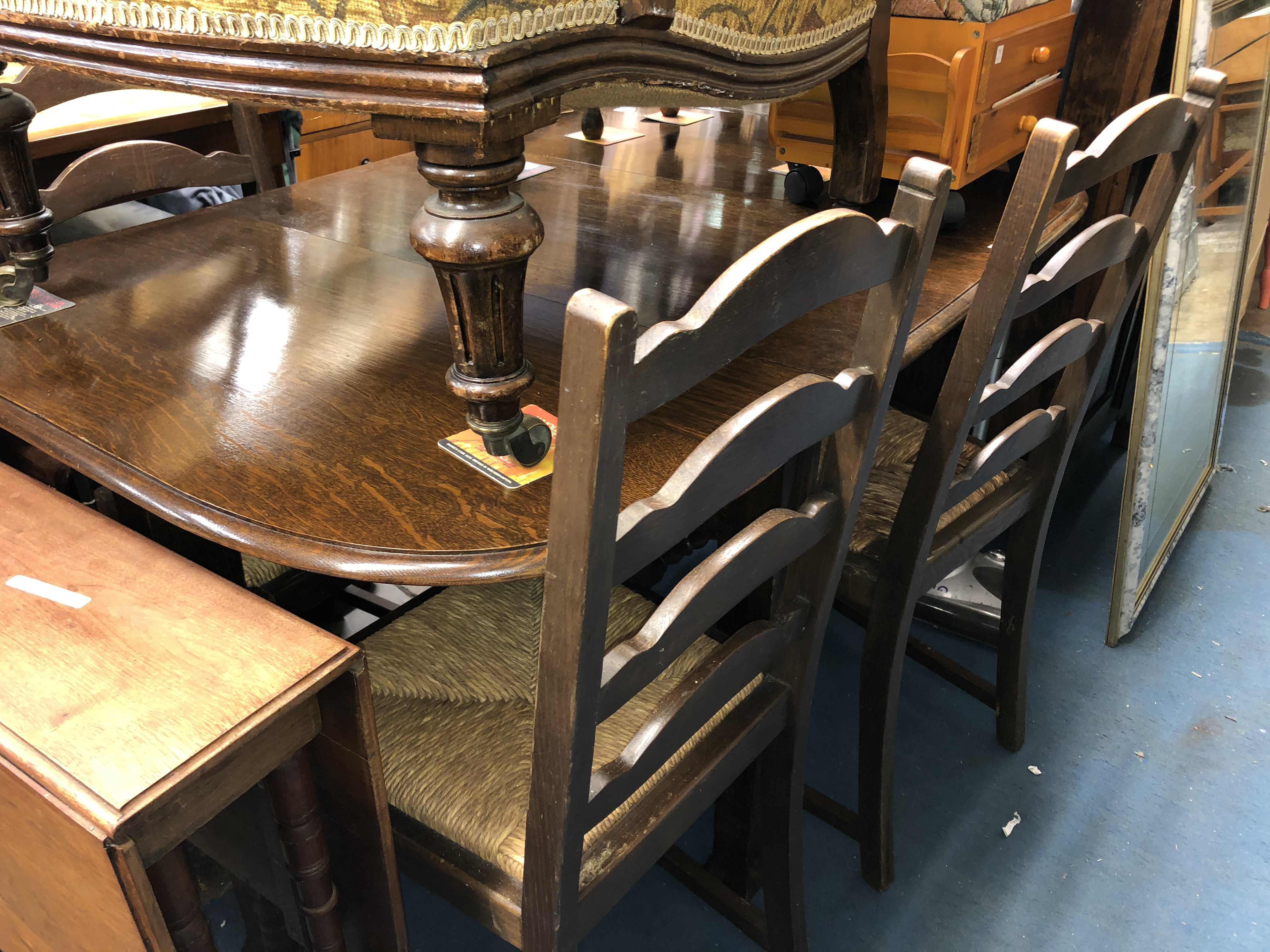 OAK OVAL DROP FLAP TABLE AND FOUR LADDER BACK CHAIRS