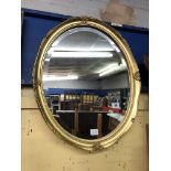 GILT SERPENTINE FRAMED BEVELLED OVAL MIRROR