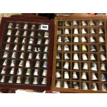 TWO GLAZED WALL CASES OF SOUVENIR OF MAINLY BONE CHINA AND METALWARE THIMBLES